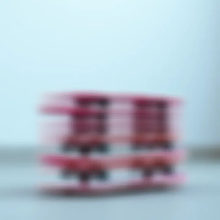 An artistic arrangement of pink skateboard decks stacked creatively.